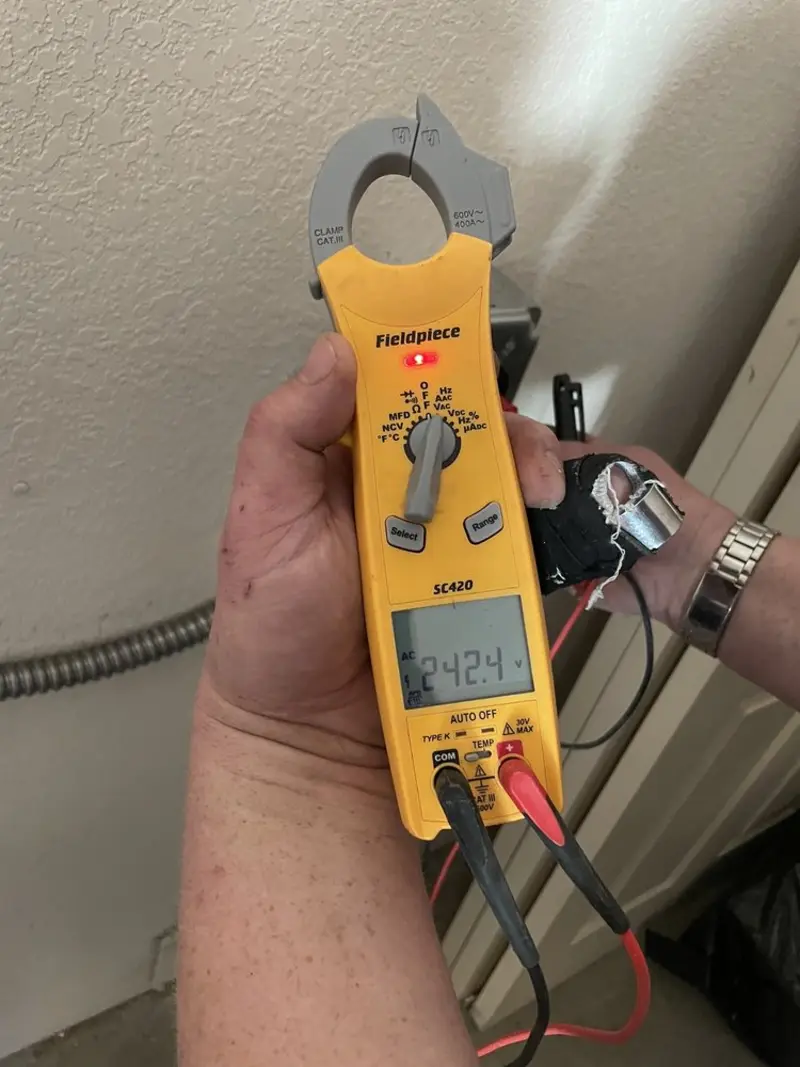 Voltage testing with clamp meter during Outlet Installation in Kirksville